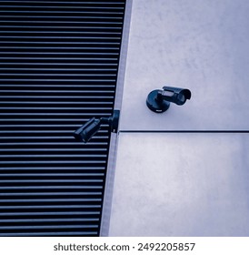 Selective focus on CCTV camera attached to the wall of a modern building.