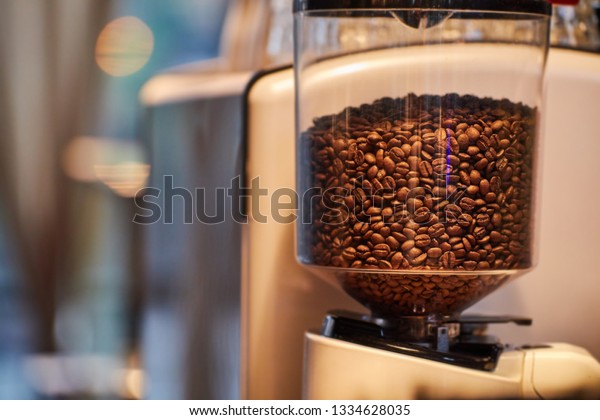 Selective focus on coffee bean machine in a\
modern vintage cafe\
restaurant.