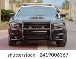 selective focus on the commanding front of a watchful police car.