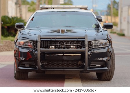 selective focus on the commanding front of a watchful police car.
