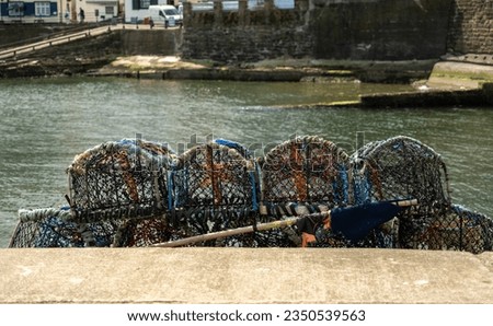 Selective focus on crab pots, lobster pots and fish traps on the quayside in the fishing village of Staithes on the North Yorkshire coast