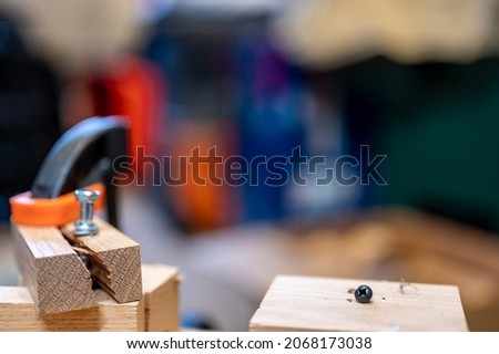 Selective focus on cracked and split wood from not drilling a pilot hole before driving a screw