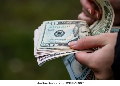 Selective Focus On Detail Of USD Banknotes. Counting Or Giving United States Dollars Banknotes. World Money Concept, Inflation And Economy Concept