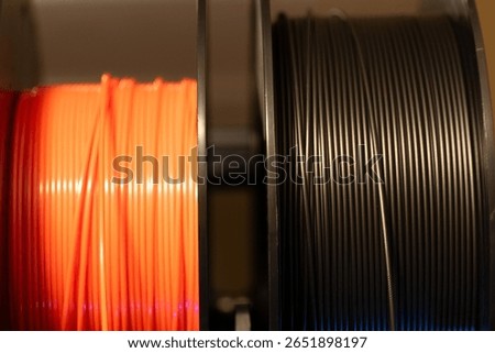 Selective focus on different colored spools of 3d printer filament 