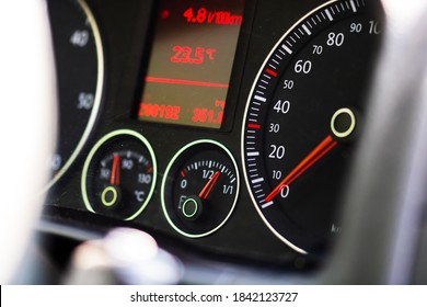 Selective focus on digital display of car isolated. Car speedometer, dashboard, tachometer and temperature gauge.