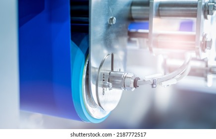 Selective Focus On Drum Motor With Blur Blue Conveyer Belt. Electric Motor In Food Factory. Stainless Steel Roller Motor. Food Industrial Equipment. Industrial Gear In Food Factory. Drum Motor Working