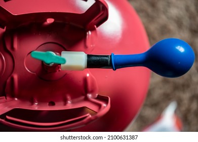 Selective focus on edge of an inflatable balloon attached to a helium canister.