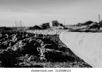 Selective Focus On Filter Sock Around Exposed Dirt At A Construction Site To Prevent Stormwater Erosion And Runoff 