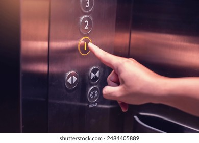 Selective focus on forefinger pressing on button in the passenger lift. Close up of elevator control panel in building. Passenger elevator cabin presses floor selection button. Knob with Bell alphabet - Powered by Shutterstock