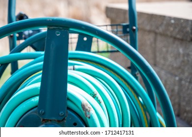 Selective Focus On Front Bar On A Wound Garden Hose Storage Cart