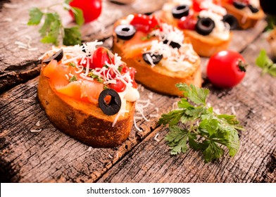 selective focus on the front bruschetta sandwich with salmon and cheese