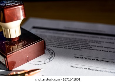 Selective focus on generic professional engineer, architecture. or surveyor stamp and certification statement - Shutterstock ID 1871641801