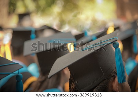 Selective Focus On Graduation Cap Of Front Female Graduate In Commencement Ceremony Row