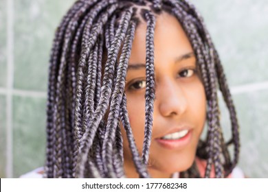 Selective focus on hair. Portrait of a young woman with box braids