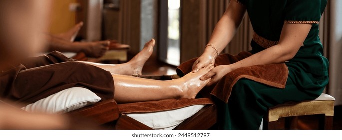 Selective focus on hand, Masseuse acupressure massage on feet of customer. Masseuse service foot massage to woman customer. Relaxation foot massage in cosmetology spa centre. - Powered by Shutterstock