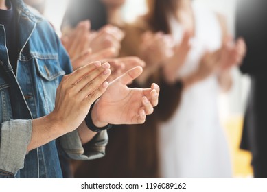 Selective Focus on hands. Creative designers audience applauding at a business seminar. Asian People listening and clapping at conference and presentation.