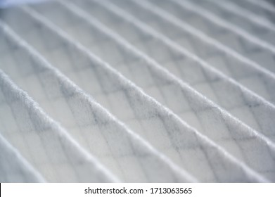 Selective focus on high resolution white fabric air filter with metal mesh visible on other side