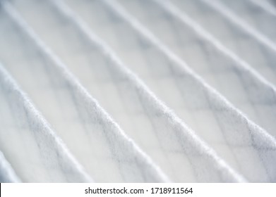 Selective focus on high resolution white fabric air filter with metal mesh visible on other side