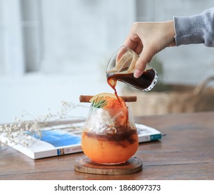 Selective Focus On Ice Orange Juice With Hand Hold Coffee Pour For Mixing In Making Drink In Home. Alternative Drinking For Healthy Living Life