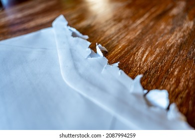 Selective Focus On Jagged Edges Of A Ripped Open Mail Envelope 