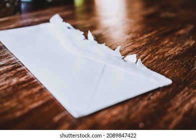 Selective Focus On Jagged Edges Of A Ripped Open Mail Envelope 