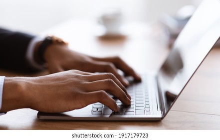 Selective focus on male hands typing on laptop keyboard, cropped, side view. African american businessman sending emails to clients or assistant. Modern technologies and business concept - Shutterstock ID 1917179723