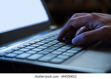 Selective Focus On Man Hand Typing Laptop/PC/computer Keyboard In Night Dark Tone Low Key