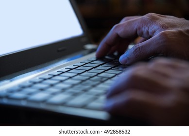 Selective Focus On Man Two Hand Typing Laptop/PC/computer Keyboard In Night Dark Tone Low Key