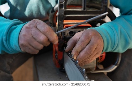selective focus on a man's hands and an old electric saw. Man restores and sharpens the blades of an electric saw