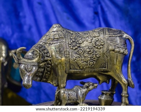 selective focus on the metal statue of a cow and a calf