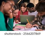 Selective focus on multiracial couple of concentrated students doing homework together using notebook sitting in study room. Group of academic diverse people working together on university campus