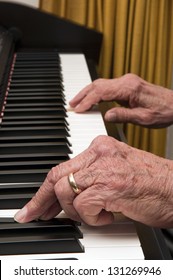 Selective Focus On Old Hands Playing The Piano