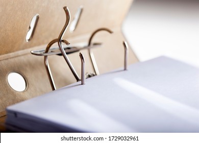 Selective focus on an opened archive ring binder with a blank paper
