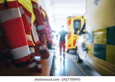 Selective focus on paramedic uniform of emergency medical service. Paramedic running to ambulance car. Themes emergency medicine, rescue, and emergency help.
