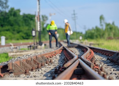 Selective focus on railway line Workers or engineers who maintain railway tracks Check the switchgear building process and check the work in the train station. - Shutterstock ID 2332840463
