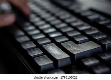 selective focus on the return key or enter key of black keyboard of desktop with human hand