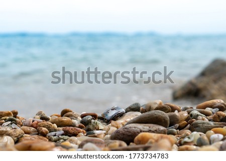 Selective focus on rocks texture with blur beach in background for display product.