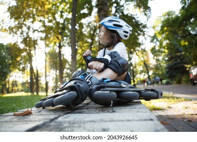 Selective focus on rollerskates young boy is wearing, resting in the park