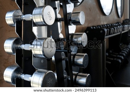 Selective focus on a row of weights in a gym