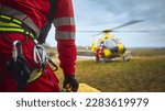 Selective focus on safety harness of paramedic of emergency service in front of helicopter. Themes rescue, help and hope.