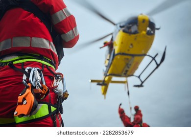 Selective focus on safety harness of paramedic of emergency service in front of helicopter. Themes rescue, help and hope.
 - Powered by Shutterstock