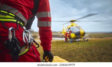 Selective focus on safety harness of paramedic of emergency service in front of helicopter. Themes rescue, help and hope. - Shutterstock ID 2283619979