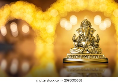 Selective focus on statue of Lord Ganesha, Ganesha Festival. Hindu religion and Indian celebration of Diwali festival concept on dark, red, yellow background. Festival and religious concept