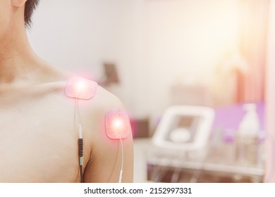Selective focus on TENS Electrode Pads prepare for treatment on shoulder pain, Electro stimulation machine in rehab room on the background in hospital, health problem and medical concept.