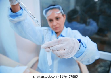 Selective Focus On A Test Tube With A Taking Place Chemical Reaction And Graduated Lab Pipette In A Blurred Woman Scientist Hands Dripping Reagent, Conducting Science Experiment In Research