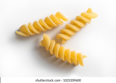 Selective focus on Three pieces of Fusilli pasta isolated on white background - Powered by Shutterstock