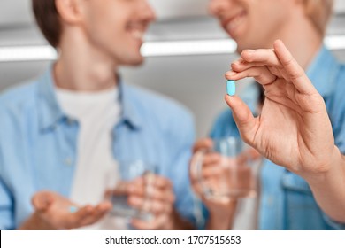 Selective Focus On Two Young Adult Homosexual Guy Holding Pre Exposure HIV Protection Pills In Hands, Showing Medicament On Camera Against Blurred Background With Copy Space