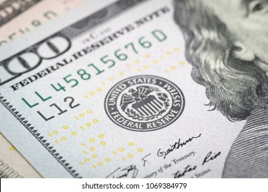 Selective Focus On US Federal Reserve Emblem On Hundred Dollars Banknote As FED Consider Interest Rate Hike, Economics And Inflation Control National Organization.