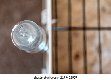 Selective Focus On A Water Bottle Mounted On The Bars Of A Small Animal Cage. 