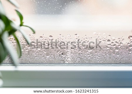 Selective focus on water condensation on window glass. Humidity in the house. Home moisture.